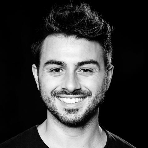 Portrait black-white photo of a smiling man with black background